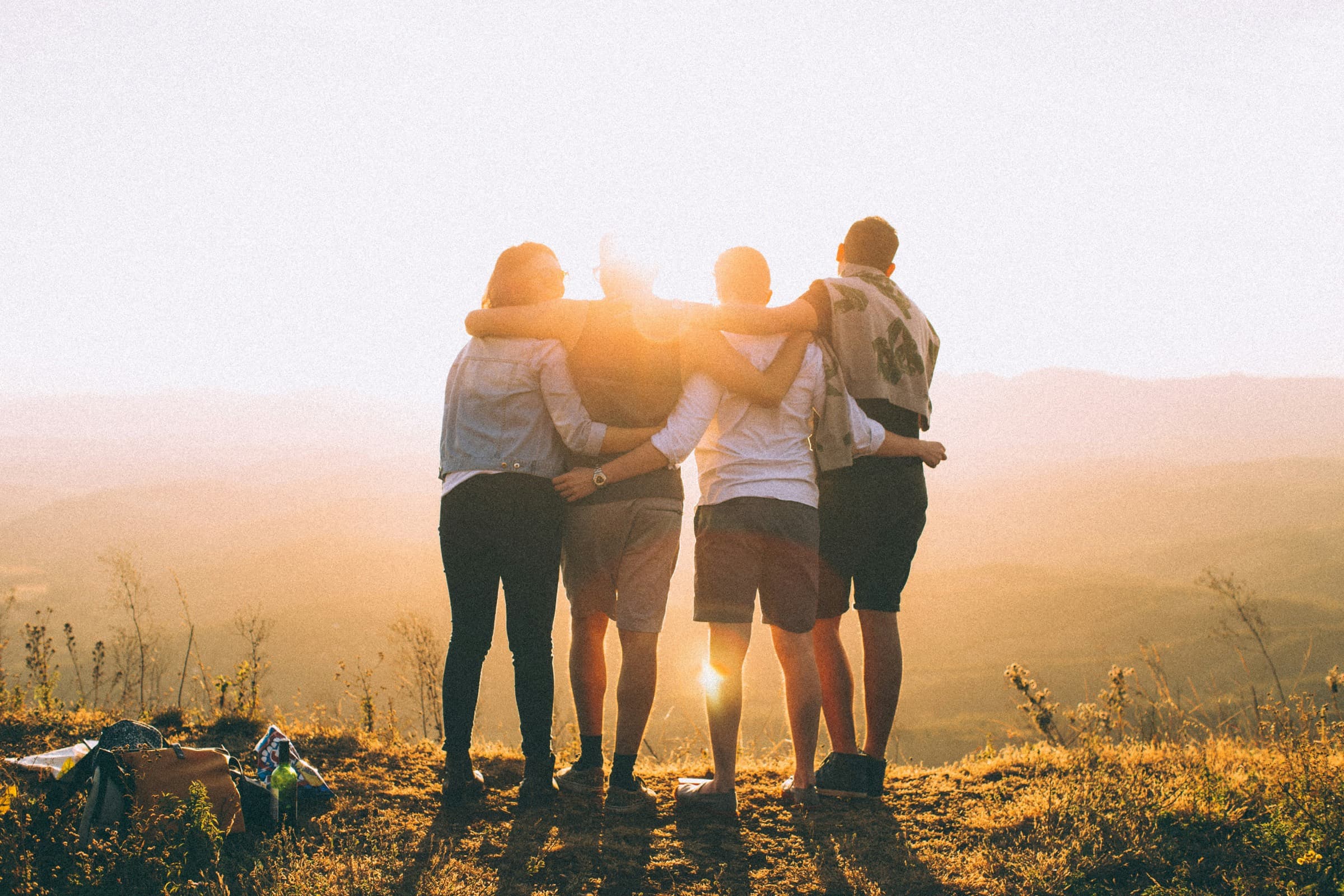 Walkers on a hilltop at golden hour